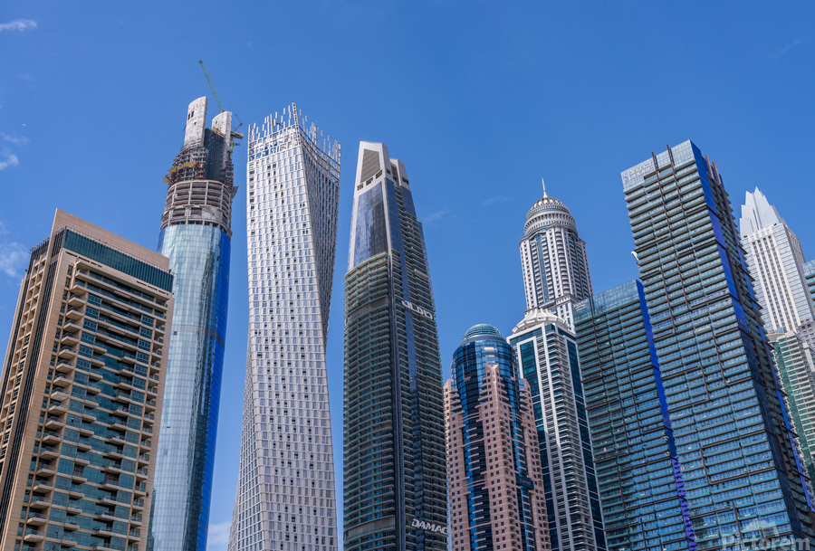 Cayan Tower among tall buildings on waterfront at Dubai Marina  Print
