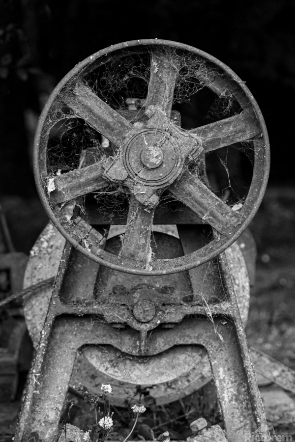 Rusty farm machinery with flywheel  Print