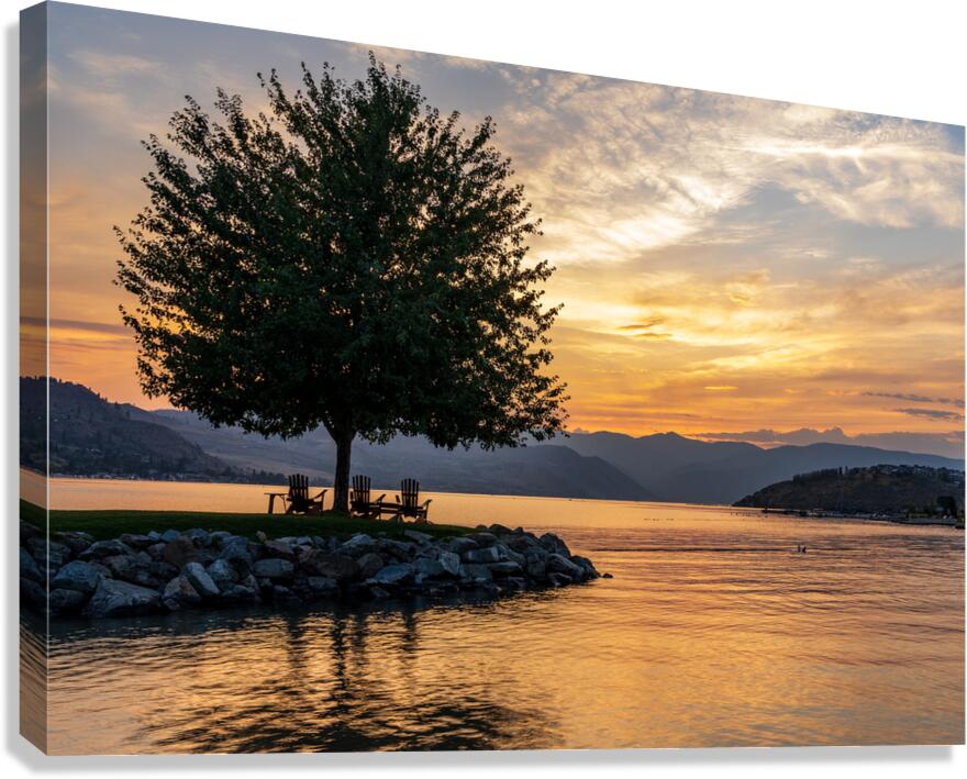 Sunset over Lake Chelan with silhouette of tree and chairs for r Canvas Print