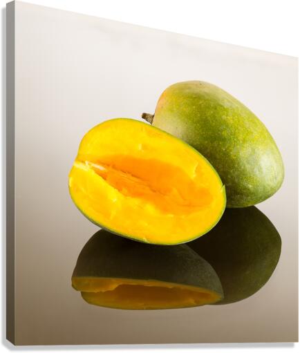 Two mangoes on reflecting surface Canvas Print