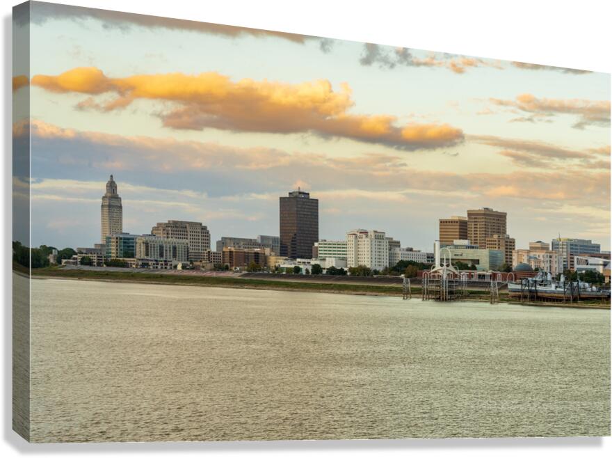 Skyline of Baton Rouge at sunset over river barges  Canvas Print