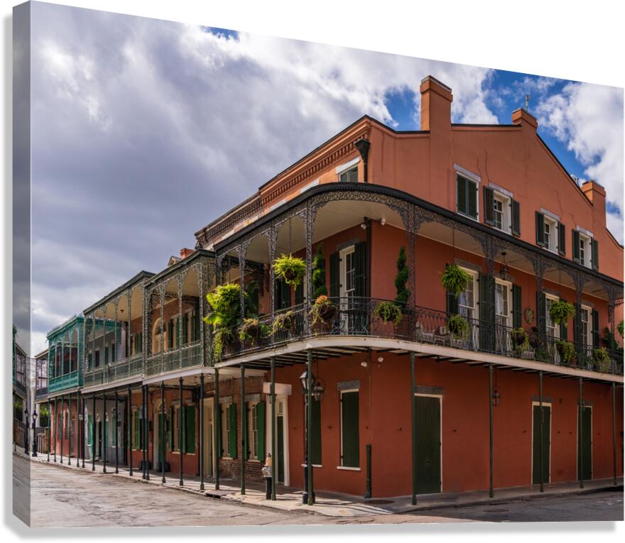 Traditional wrought iron balcony on ochre New Orleans house Canvas Print