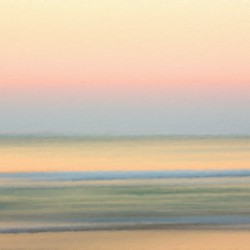 Sunrise over ocean with sideways pan