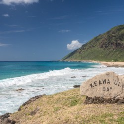 Winter waves crash on the sandy shore at Kaewaula beach on Oahu