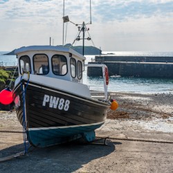 Fishing boat in old harbour at Mullion Cove in Cornwall