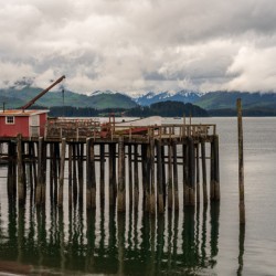 Old wooden pier structure in bay at Icy Strait Point in Alaska