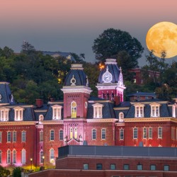 Moonrise over illuminated Woodburn Hall at WVU Morgantown