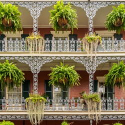 Traditional wrought iron balcony on brick New Orleans house