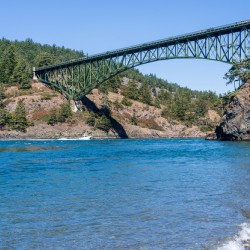 Turbulent water of Deception Pass under historic cantilevered br