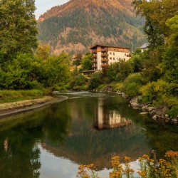 Alpine German apartment building relfects in River Wenatchee in 