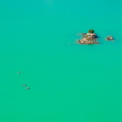 Three paddleboards float away from island in Diablo Lake in Nort