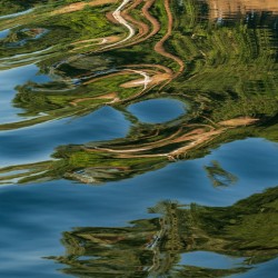 Sailboat on Nile River with ripples in the reflection from passi