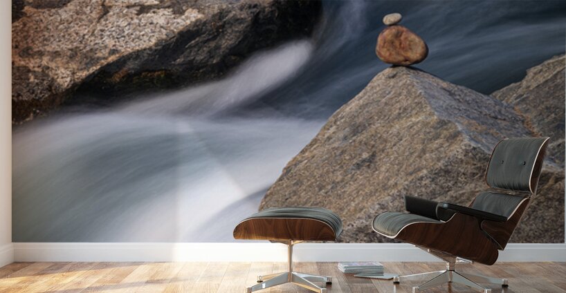 Pebbles balanced on rocks in raging river illustrating resilienc Wall Murals