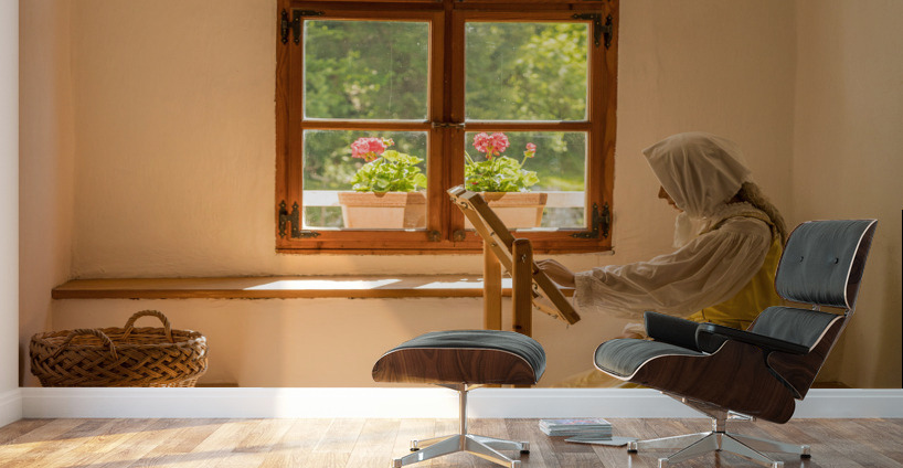 Woman working on embroidery in window alcove Wall Murals