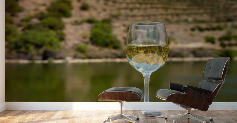 Glass of white wine by Douro river in Portugal Wall Murals