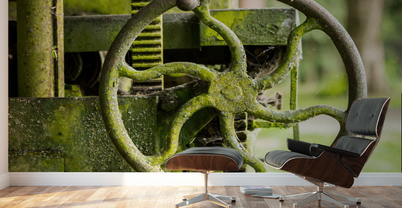 Moss covered farm machinery with handle Wall Murals