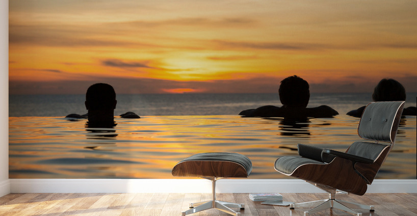 Silhouetted heads against infinity edge pool Wall Murals