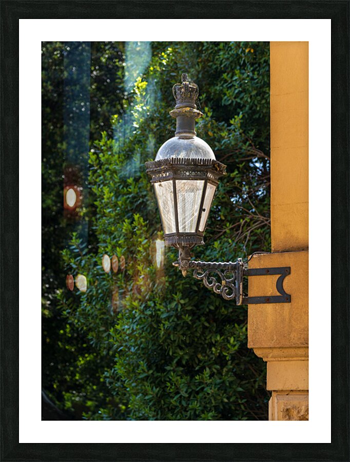 Historic english street lantern attached to warm stone building Picture Frame print