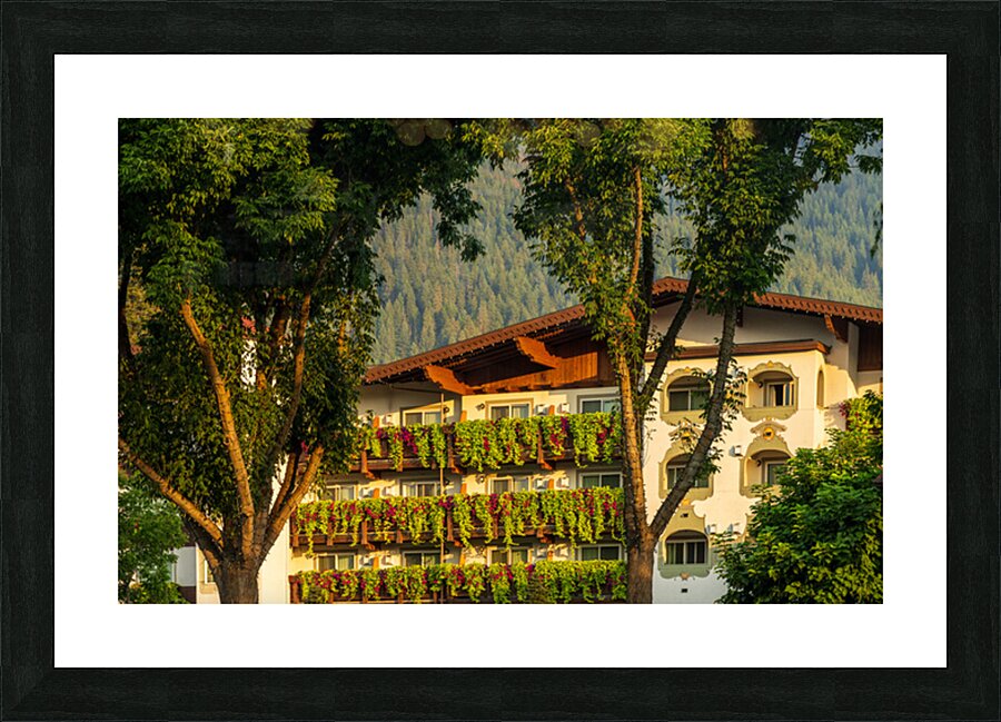 Flower strewn balconies of a hotel in Alpine village of Leavenwo Picture Frame print