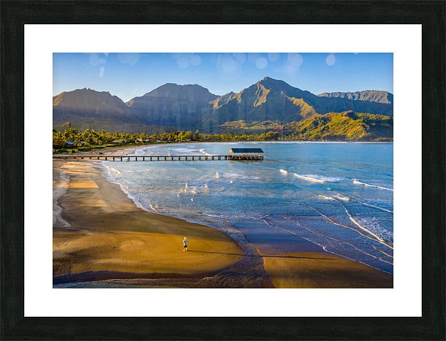 Aerial drone shot of man on the sand of Hanalei beach  Picture Frame print