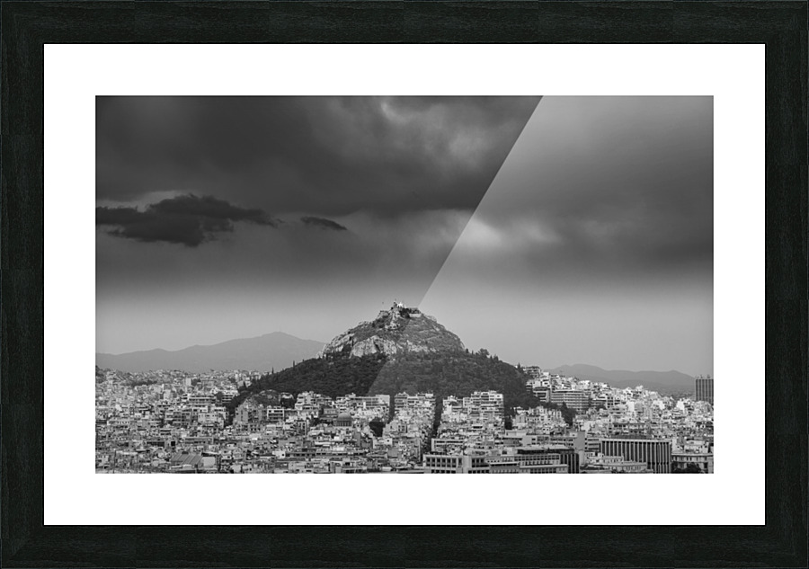 Lycabettus hill rises above Athens in a storm Picture Frame print