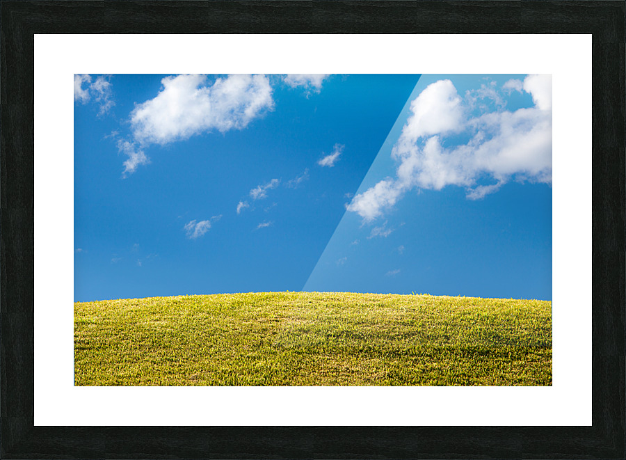 Green grassy lawn with blue sky and clouds Picture Frame print