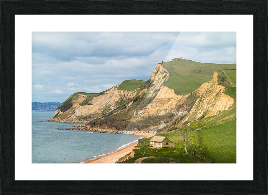 Cottage by cliffs at West Bay Dorset in UK Picture Frame print