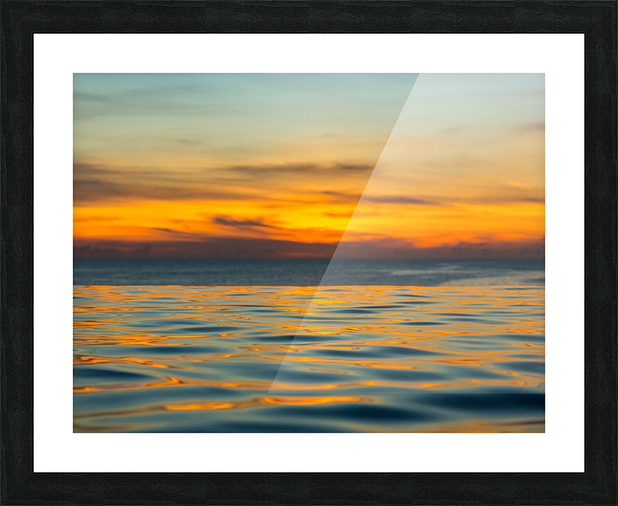 Infinity edge pool with sea underneath sunset Picture Frame print