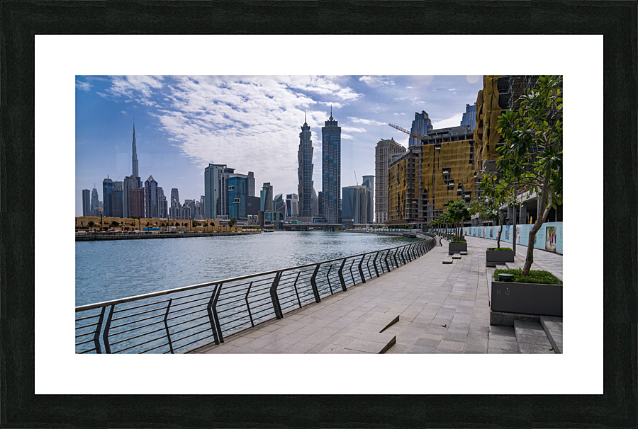 Low rise homes in front of modern apartments of Dubai Downtown d Picture Frame print