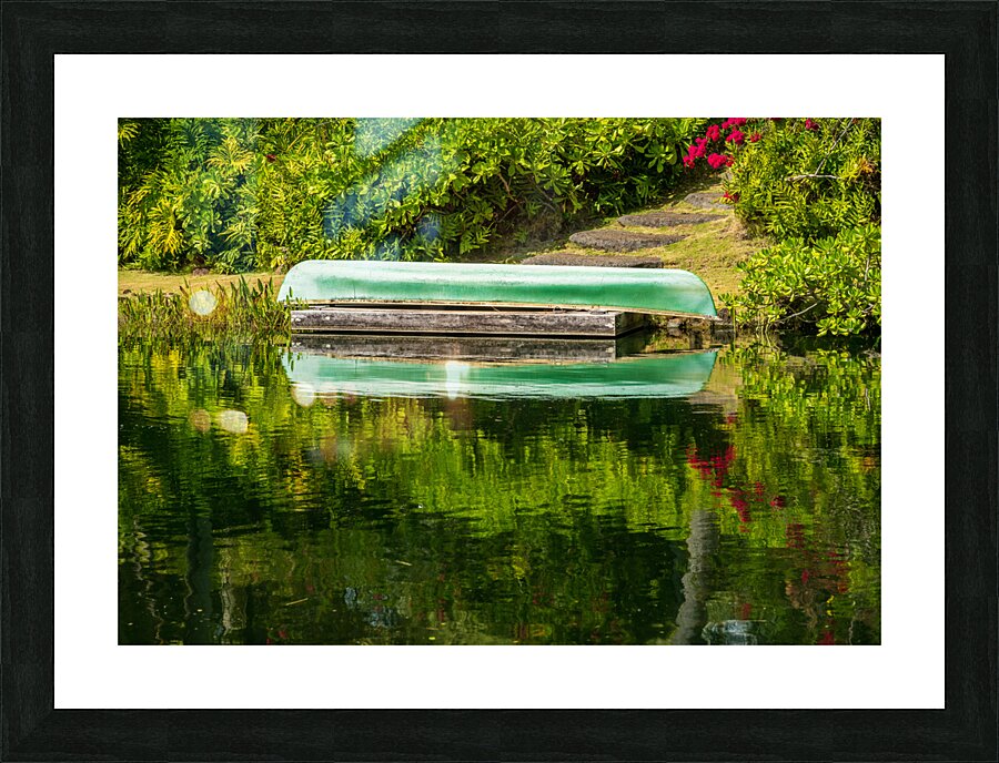 Green canoe on dock reflecting into calm lake or pond in garden Picture Frame print
