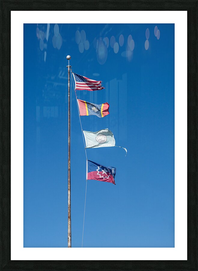 Flagpole with multiple flags in the small town of Greenville MS Picture Frame print