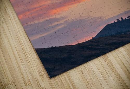 Fiery sunset clouds enveloping the new crescent moon over Lake C Steve Heap puzzle