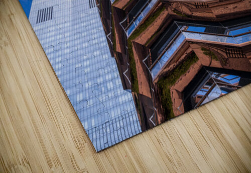 Reflective surface of the Vessel with a skyscraper behind with c Steve Heap puzzle