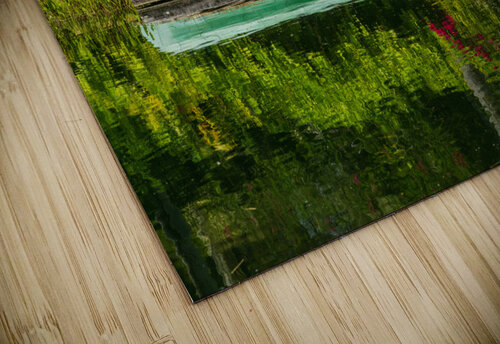 Green canoe on dock reflecting into calm lake or pond in garden Steve Heap puzzle