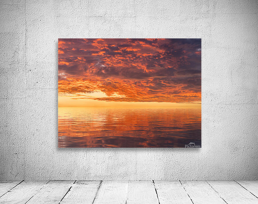 Dramatic sunset reflected in the smooth ripples of a lake or oce Wall Preview