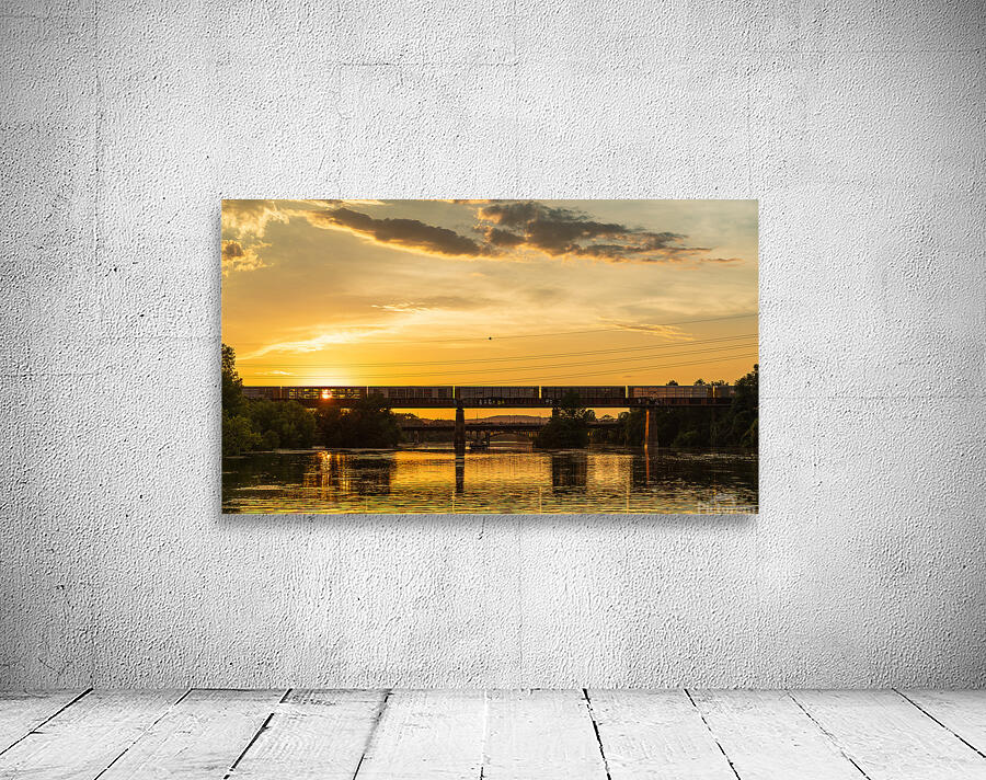 Freight train on the railroad bridge in Austin at sunset Wall Preview