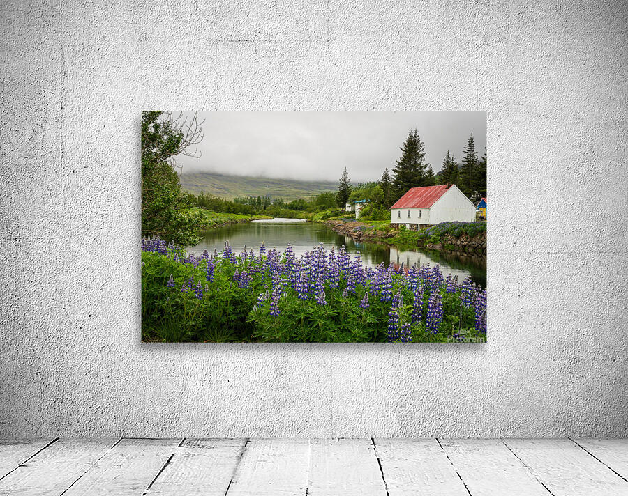 Peaceful scene in Seydisfjordur of river flowing from misty moun Wall Preview