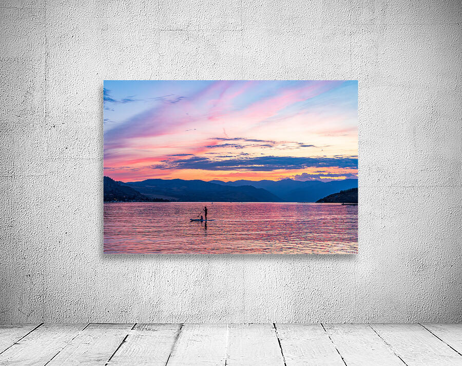 Sunset over Lake Chelan with silhouette of couple paddling on pa Wall Preview