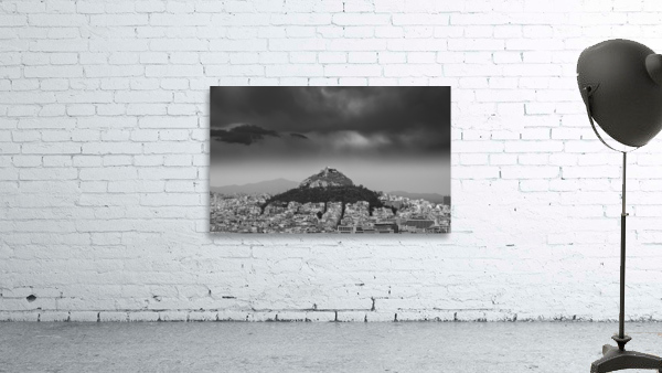 Lycabettus hill rises above Athens in a storm Wall Preview