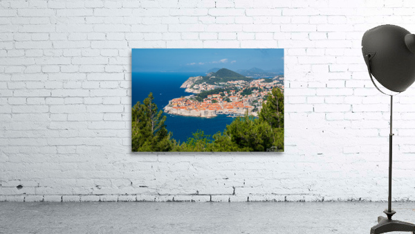 Fortress town of Dubrovnik in Croatia framed by trees Wall Preview