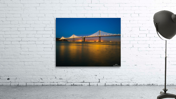 San Francisco Bay bridge illuminated at night Wall Preview