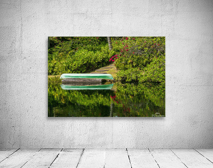 Green canoe on dock reflecting into calm lake or pond in garden Wall Preview
