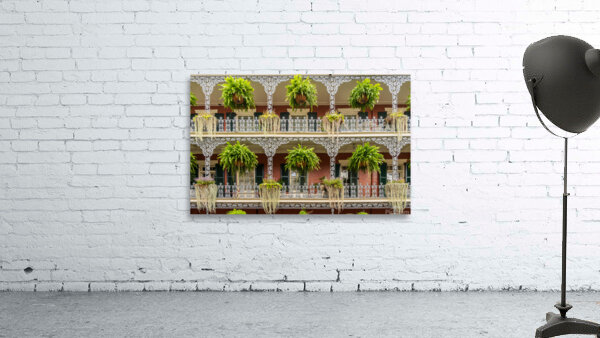 Traditional wrought iron balcony on brick New Orleans house Wall Preview