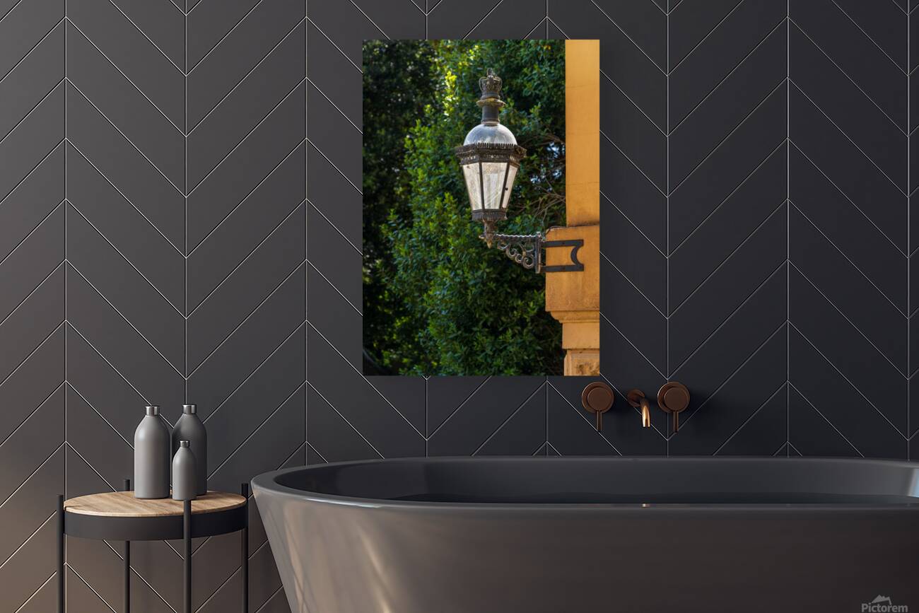 Historic english street lantern attached to warm stone building Reproduction