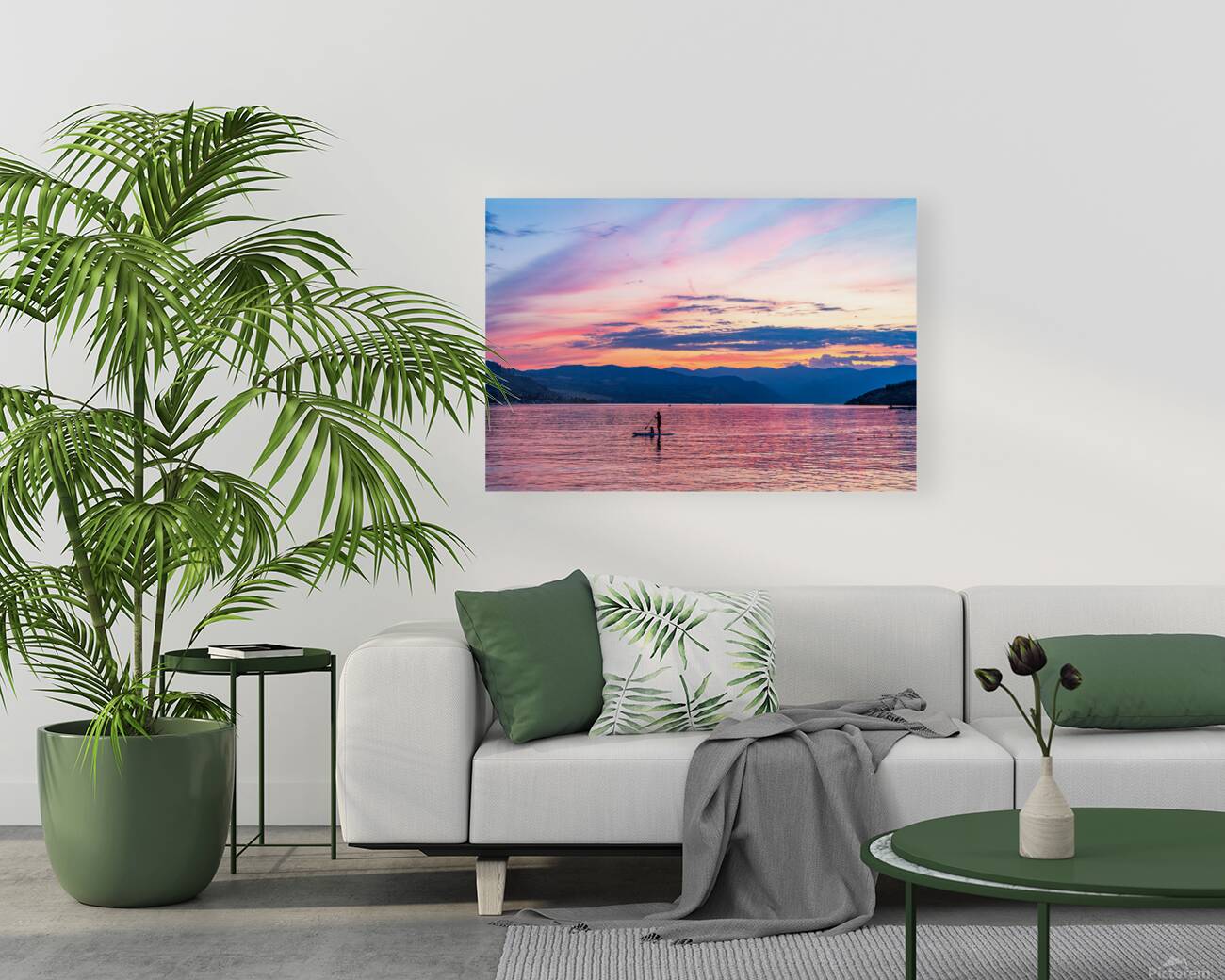 Sunset over Lake Chelan with silhouette of couple paddling on pa Reproduction