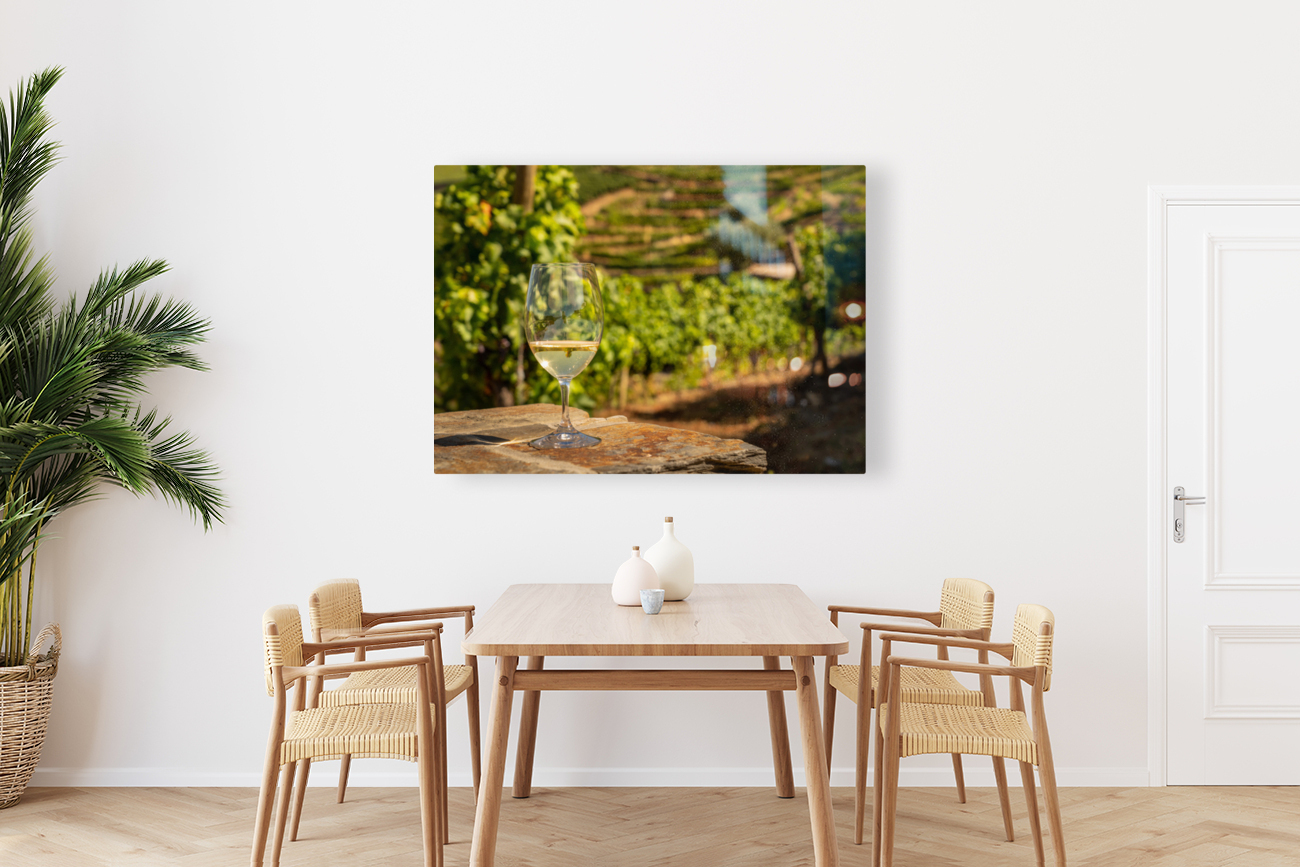 Glass of white wine in vineyard Reproduction