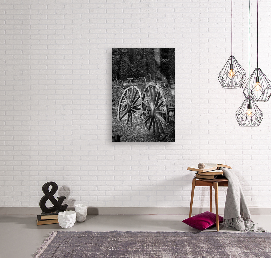 Two old wooden cartwheels against wood cart Reproduction