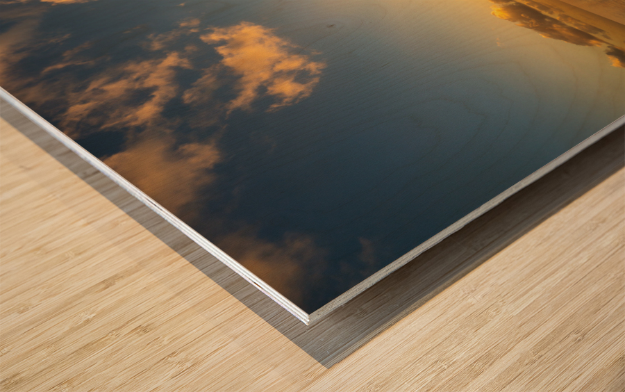 Beautiful sunset reflected in a calm peaceful ocean Wood print